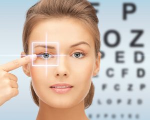 medicine, eyesight control, laser correction, people and health concept - beautiful young woman pointing finger to her eye and over blue background with eye chart